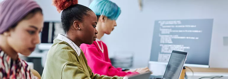 Gen Z at work on laptops in a modern office